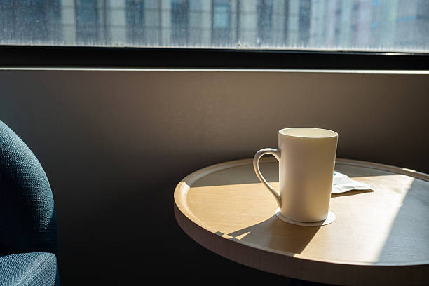 Morning light through a window with a cup of tea on a bedside table